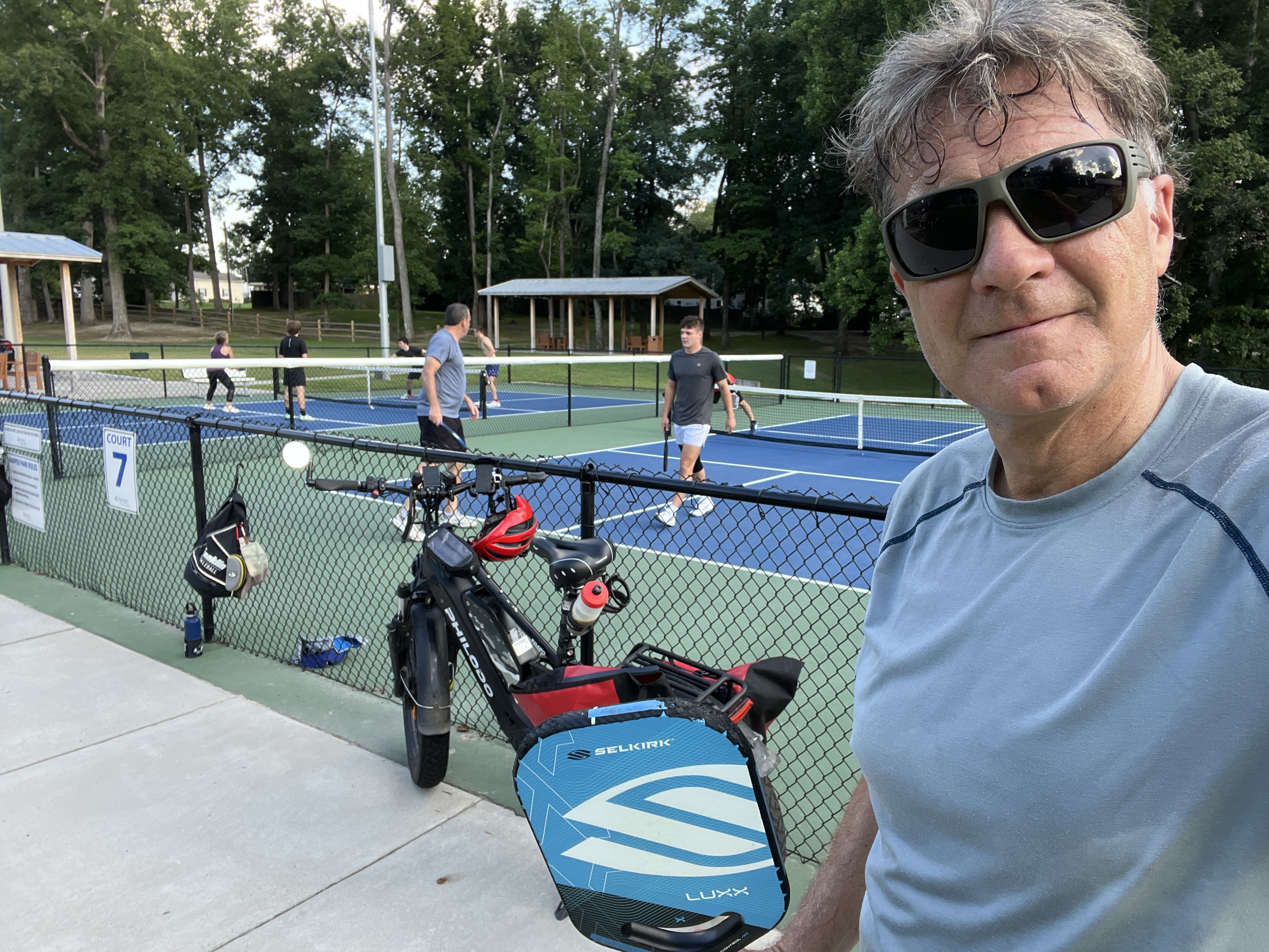 Rick holding his Selkirk pickleball paddle at the courts