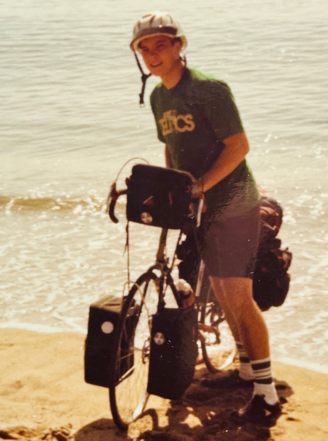 18-year-old Rick Brown with his touring bike on the California coast after riding from Maine