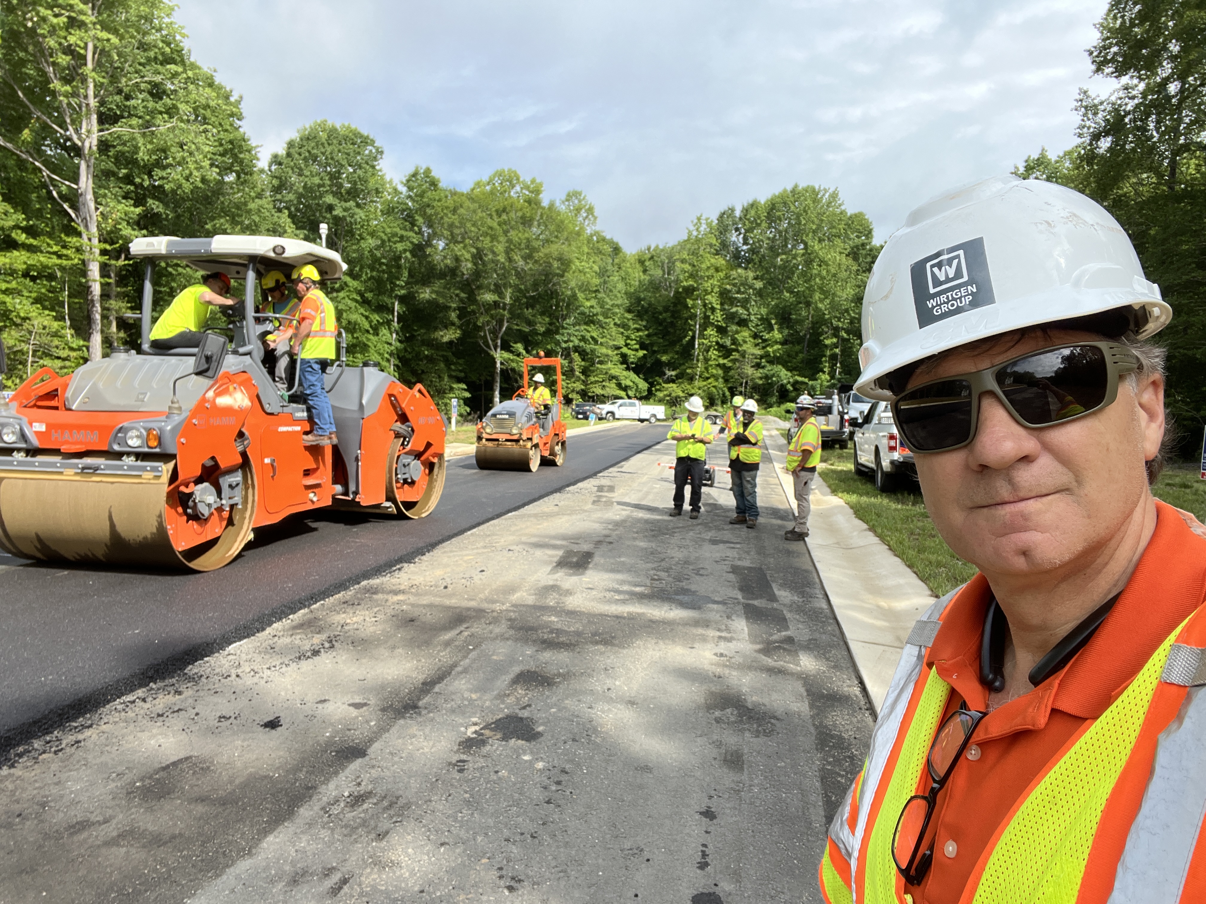 Rick in hard hat at a road paving job site