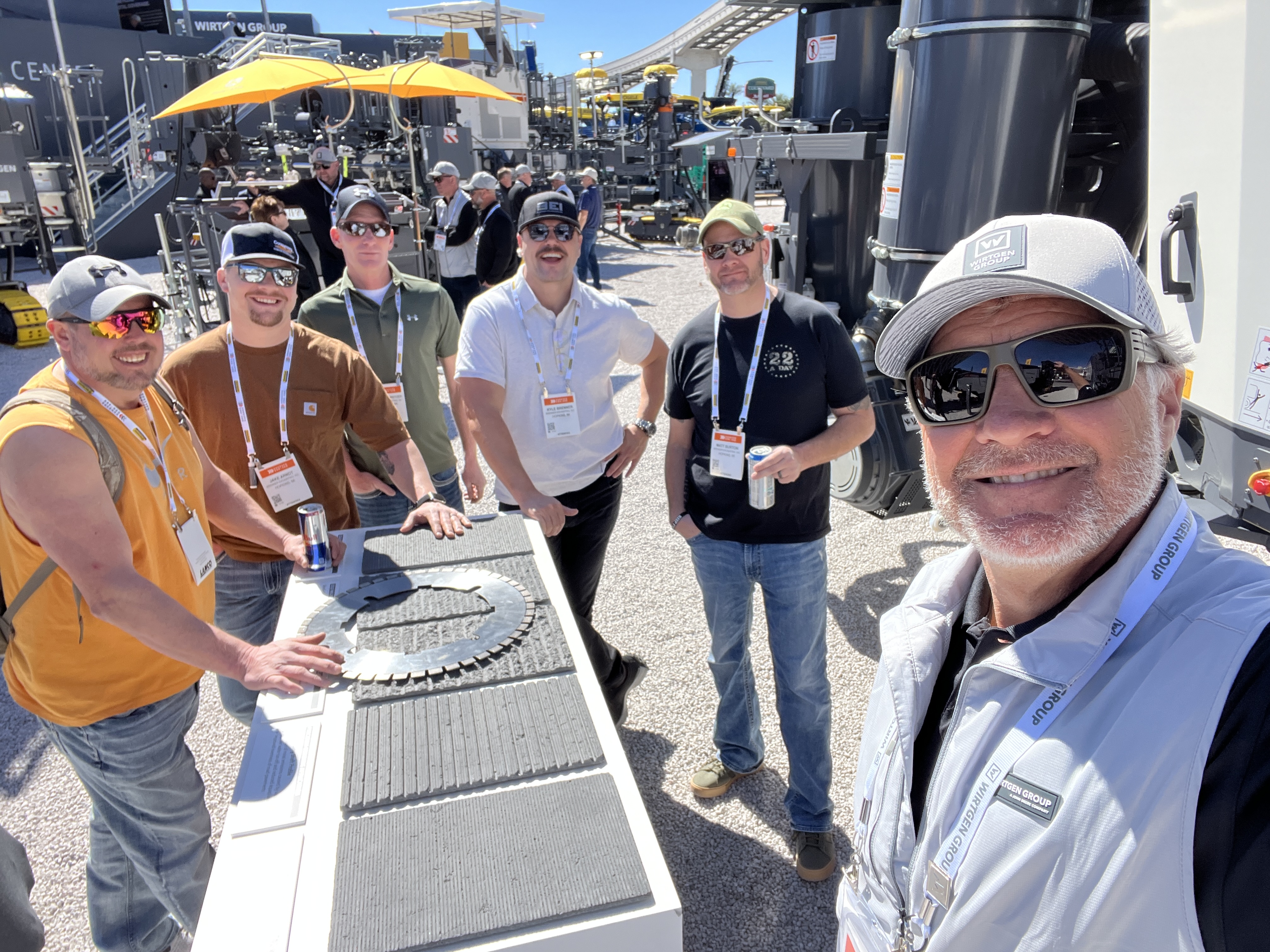 Rick with colleagues at a heavy equipment trade show